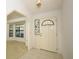 Bright entryway featuring tile flooring, a decorative front door with stained glass, and an archway to another room at 7703 Pine Vista Ct, Orlando, FL 32819