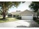 Charming single-story home with a well-manicured front yard and a spacious driveway leading to a two-car garage at 7703 Pine Vista Ct, Orlando, FL 32819