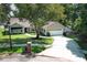 Aerial view of the charming home showcasing its manicured lawn, landscaped yard, and inviting curb appeal at 7703 Pine Vista Ct, Orlando, FL 32819