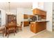 An eat-in kitchen features a dining table, wood cabinets and stainless steel appliances at 7703 Pine Vista Ct, Orlando, FL 32819