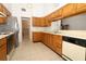 Kitchen featuring tile floors, wood cabinets and a stainless-steel refrigerator at 7703 Pine Vista Ct, Orlando, FL 32819