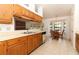 Spacious kitchen with tiled floors, wood cabinetry and a dining nook with large windows at 7703 Pine Vista Ct, Orlando, FL 32819