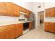 Kitchen with tile floors, wood cabinetry and stainless-steel refrigerator at 7703 Pine Vista Ct, Orlando, FL 32819