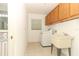 Functional laundry room with a washer, dryer, utility sink, and storage cabinets at 7703 Pine Vista Ct, Orlando, FL 32819