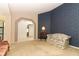 Bright living room featuring carpet floors, archway, and eclectic furnishings at 7703 Pine Vista Ct, Orlando, FL 32819