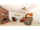Cozy living room features a brick fireplace, ceiling fan, and French doors at 7703 Pine Vista Ct, Orlando, FL 32819