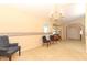Spacious living area with neutral carpet, chandelier and a small octagon window at 7703 Pine Vista Ct, Orlando, FL 32819