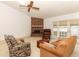 Inviting living room with brick fireplace, ceiling fan, and sliding glass doors to the patio at 7703 Pine Vista Ct, Orlando, FL 32819