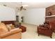Cozy living room featuring a brick fireplace and comfortable seating at 7703 Pine Vista Ct, Orlando, FL 32819