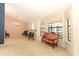 Open living room with large windows, carpet flooring, and a classic chandelier at 7703 Pine Vista Ct, Orlando, FL 32819