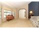 Spacious living room with neutral carpet, a bay window, and decorative wallpaper accents at 7703 Pine Vista Ct, Orlando, FL 32819