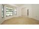 Cozy living room with large bay windows offering natural light and neutral carpet at 7703 Pine Vista Ct, Orlando, FL 32819