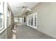 Bright sunroom with large windows, ceiling fans, and French doors to the outdoors at 7703 Pine Vista Ct, Orlando, FL 32819