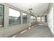 Spacious sunroom with lots of windows and two ceiling fans at 7703 Pine Vista Ct, Orlando, FL 32819
