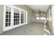 Bright sunroom featuring French doors and multiple windows offering ample natural light at 7703 Pine Vista Ct, Orlando, FL 32819