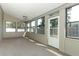 Inviting sunroom with a ceiling fan, many windows, and a convenient side door at 7703 Pine Vista Ct, Orlando, FL 32819