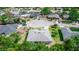 An aerial perspective of the home nestled in a serene neighborhood with lush trees and well-maintained lawns at 825 White Birch Ct, Orange City, FL 32763