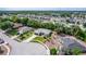 This aerial view highlights a home in a quiet neighborhood with mature trees and manicured lawns at 825 White Birch Ct, Orange City, FL 32763