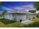 The back of the house has a screened in porch and a patio with grass at 825 White Birch Ct, Orange City, FL 32763