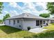 The back of the house has a screened in porch and a patio with grass at 825 White Birch Ct, Orange City, FL 32763