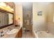 Relaxing bathroom featuring a garden tub and a large vanity at 825 White Birch Ct, Orange City, FL 32763