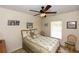 Comfortable bedroom with ceiling fan, a decorative bed, and natural light from the window at 825 White Birch Ct, Orange City, FL 32763
