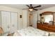 Bedroom with ceiling fan, a decorative bed, dresser with mirror and a closet for ample storage at 825 White Birch Ct, Orange City, FL 32763