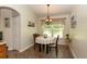 Cozy dining area features a round table, chandelier, and natural light from the nearby windows at 825 White Birch Ct, Orange City, FL 32763