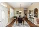 Formal dining room featuring a marble table, wainscoting, and a decorative chandelier at 825 White Birch Ct, Orange City, FL 32763