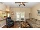 Inviting living room with a ceiling fan and French doors to the patio at 825 White Birch Ct, Orange City, FL 32763