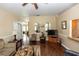Cozy living room featuring wood floors and neutral walls with chair rail at 825 White Birch Ct, Orange City, FL 32763