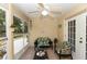 Inviting sunroom with comfortable seating, ceiling fan and sliding glass doors to the backyard at 825 White Birch Ct, Orange City, FL 32763