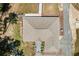 Overhead view of a home's roof, driveway, and manicured landscaping at 8660 Sw 137Th Ct, Dunnellon, FL 34432