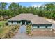 Aerial view of single-story house showcasing landscaping, roof, and inviting curb appeal at 8660 Sw 137Th Ct, Dunnellon, FL 34432
