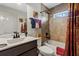 Cozy bathroom with shower-tub combo, dark fixtures, and decorative accents at 8660 Sw 137Th Ct, Dunnellon, FL 34432