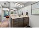 Bathroom features a double vanity with dark cabinets at 8660 Sw 137Th Ct, Dunnellon, FL 34432