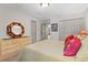 Bright bedroom features an octagonal mirror, fresh paint, and plush bedding at 8660 Sw 137Th Ct, Dunnellon, FL 34432