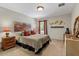 Cozy bedroom featuring a comfortable bed, decorative art, and a window with natural light at 8660 Sw 137Th Ct, Dunnellon, FL 34432