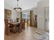 Dining room features an elegant chandelier, rich wood table with seating for six, and stylish window coverings at 8660 Sw 137Th Ct, Dunnellon, FL 34432