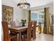 Bright dining area boasts a decorative dragon accent piece, a wooden table, and a stylish chandelier at 8660 Sw 137Th Ct, Dunnellon, FL 34432