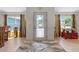 Stylish entryway featuring glass front door and elegant tile flooring at 8660 Sw 137Th Ct, Dunnellon, FL 34432