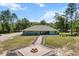 Charming single-story home with a fire pit and landscaped front yard at 8660 Sw 137Th Ct, Dunnellon, FL 34432