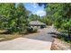 Beautiful home surrounded by mature trees and landscaping and a long driveway at 8660 Sw 137Th Ct, Dunnellon, FL 34432