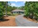 A tranquil home set back from a long driveway amidst lush greenery at 8660 Sw 137Th Ct, Dunnellon, FL 34432