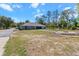 Large exterior backyard with grass, trees, landscaping, firepit, and a well-maintained lawn at 8660 Sw 137Th Ct, Dunnellon, FL 34432