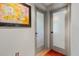 Hallway featuring two frosted glass doors with black hardware and adjacent colorful wall art at 8660 Sw 137Th Ct, Dunnellon, FL 34432