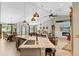 Open-concept kitchen featuring an island with seating, a wine cooler, and views into the dining and living areas at 8660 Sw 137Th Ct, Dunnellon, FL 34432