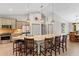 Spacious kitchen with a large island and seating, modern appliances, and stylish pendant lighting at 8660 Sw 137Th Ct, Dunnellon, FL 34432