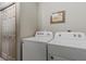 Bright laundry room with a side-by-side washer and dryer at 8660 Sw 137Th Ct, Dunnellon, FL 34432