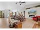 Spacious living room with a contemporary fireplace, comfortable seating, and plenty of natural light at 8660 Sw 137Th Ct, Dunnellon, FL 34432